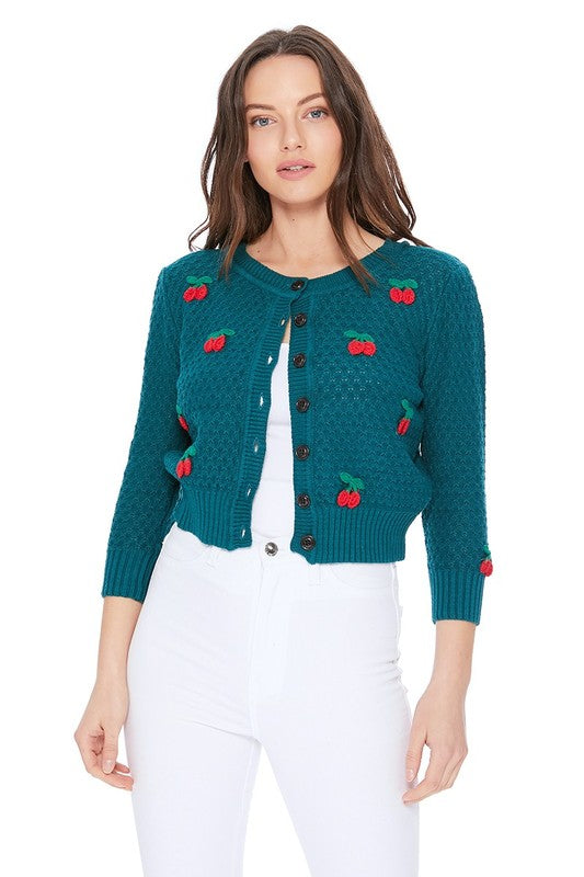 Suéter tipo cárdigan corto con pompones y crochet de cereza